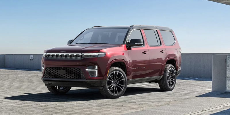 A gray Wagoneer SUV parked on a rooftop or open platform