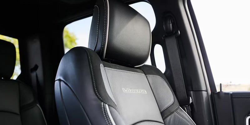 Close-up of a black leather vehicle seat with contrast stitching