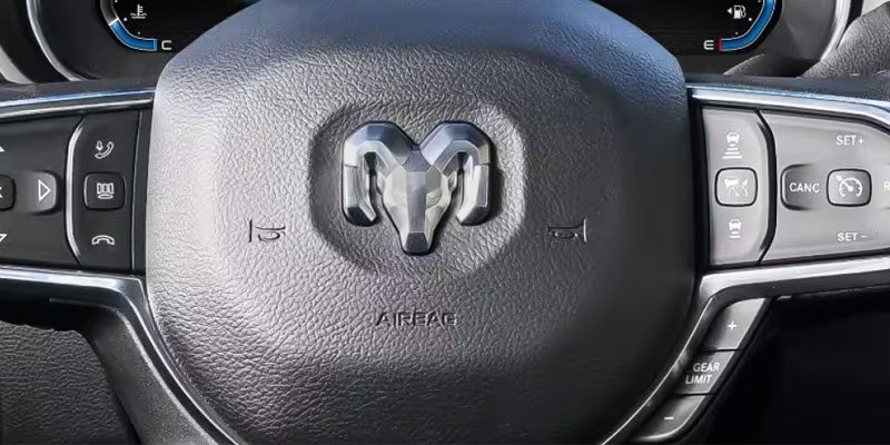 Close-up of a black leather vehicle seat with contrast stitching